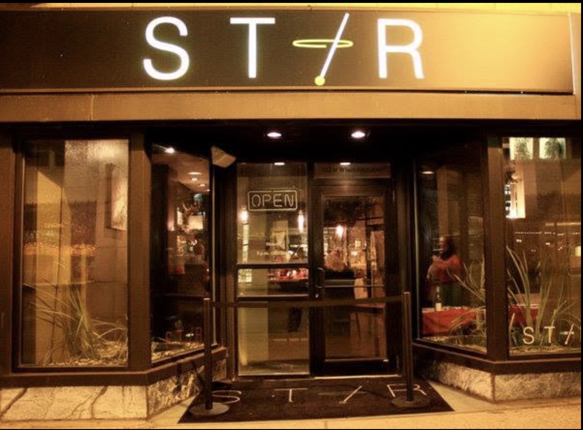 The warmly lit entrance to Stir Cocktail Lounge